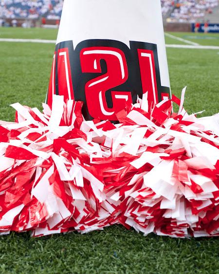 red and white pompoms sit at the base of a JSU megaphone